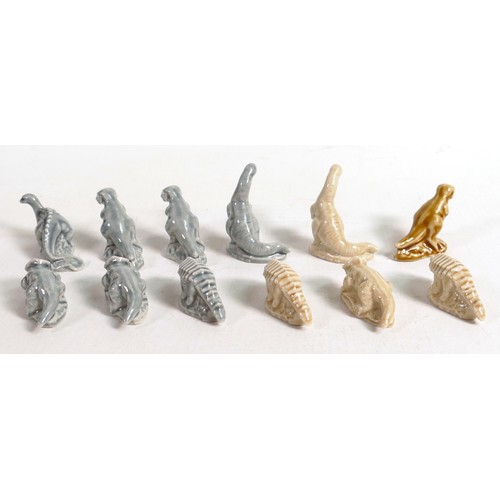 391 - A collection of Wade dinosaur hollow Whimsies in two different colours. These were removed from the ... 