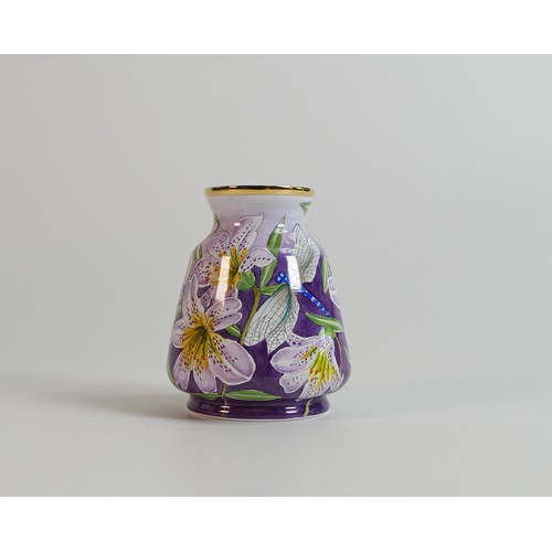 510 - Moorcroft enamelled vase decorated with purple lilies. Height 6.5cm. Boxed