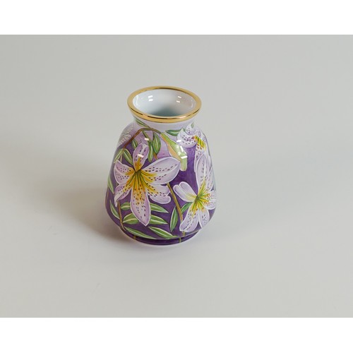 510 - Moorcroft enamelled vase decorated with purple lilies. Height 6.5cm. Boxed