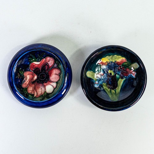 556 - Two small Moorcroft footed dishes in Orchid and Anemone designs, d.11cm. (2)