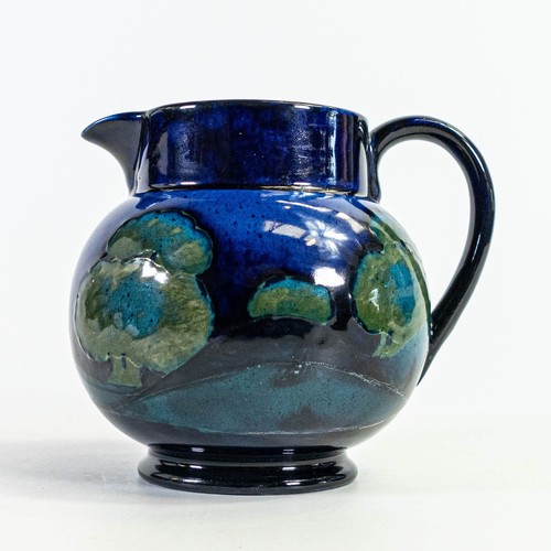 568 - William Moorcroft jug in Moonlit Blue design c.1925. Height 11.5cm