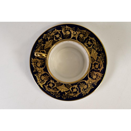 604 - Lynton Fine Porcelain coffee can & saucer, gilded on blue ground, hand painted with flowers by Stefa... 