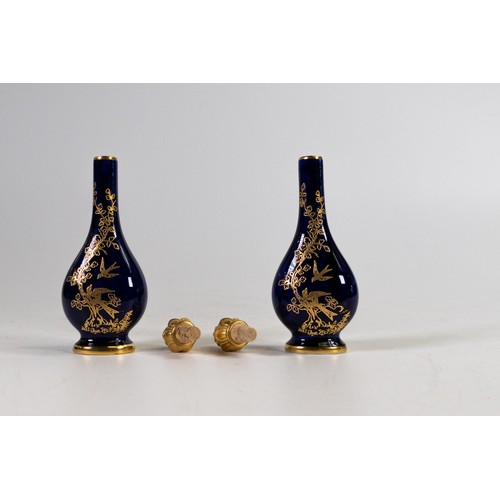 610 - Lynton Fine Porcelain pair of scent bottles and stoppers, gilded with birds on dark blue ground by S... 