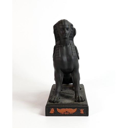 666 - Wedgwood black Basalt model of a Sphinx with terracotta Egyptian designs, dated 1973, h.22.5cm.