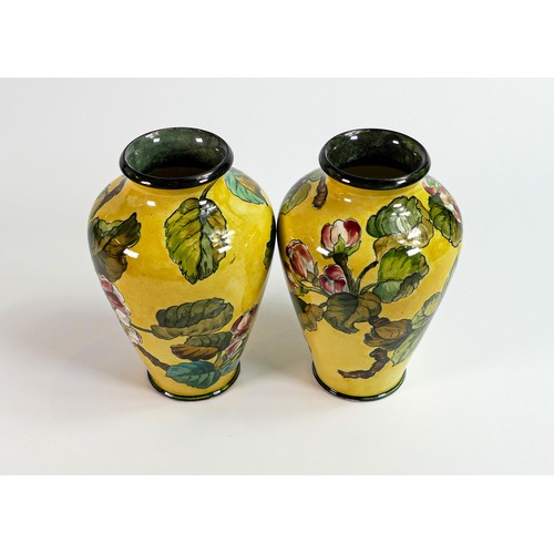 1116 - Pair of Pinder Bourne & Co. Faience vases, each decorated with flowers on yellow ground by Fanny Sta... 