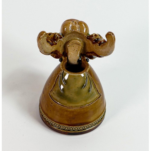 1124 - Royal Doulton Lambeth inkwell and cover in the form of a baby in a dress, h.9.5cm.