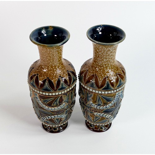 1126 - A pair of Doulton Lambeth Stoneware vases decorated with flower heads and leaves by Margaret Aitken,... 