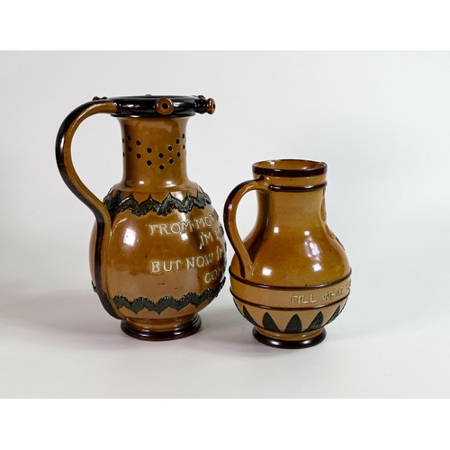 1141 - Doulton Lambeth Stoneware puzzle jug and a similar Bacchus drinking jug, tallest h.23cm, c1880s. Sma... 