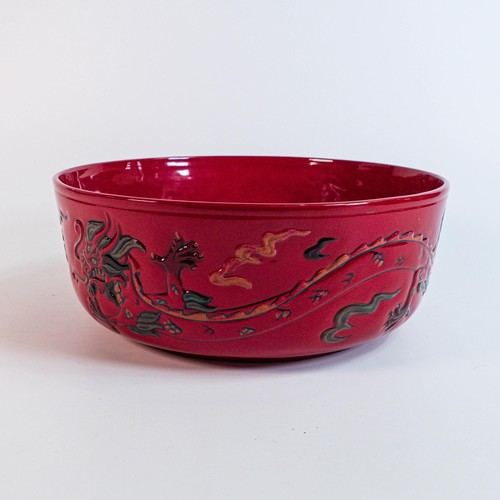 1217 - Royal Doulton Chinese Dragon Flambe bowl, modelled in low relief with two ferocious beasts amidst cl... 