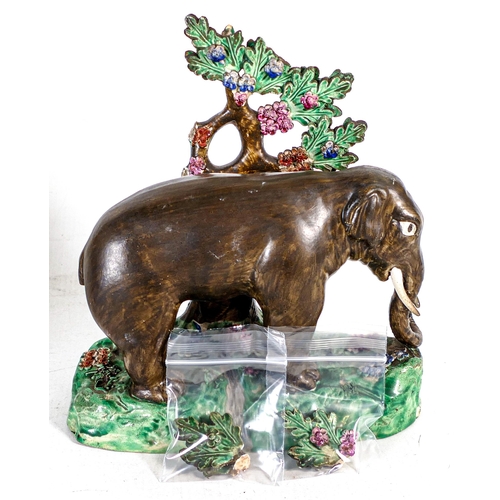 1432 - Early 19th century Staffordshire figure of elephant with bocage, decorated in overglaze enamels. Los... 