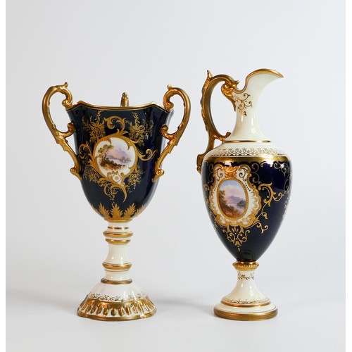 1625 - Coalport tri handled urn and handled ewer, both gilded & hand painted with panels of landscape scene... 