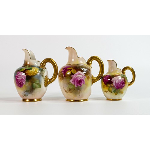 1874 - A graduated set of Royal Worcester gilded ewers, painted with roses, the larger one signed Austin an... 