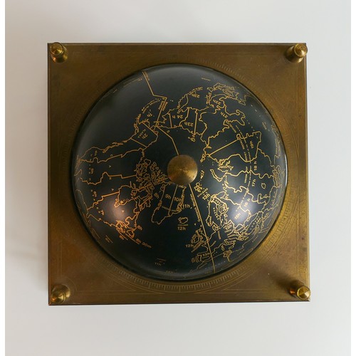 2022 - Royal Geographical Society world clock with gilt and black decoration on a wooden stand.  28cms high... 