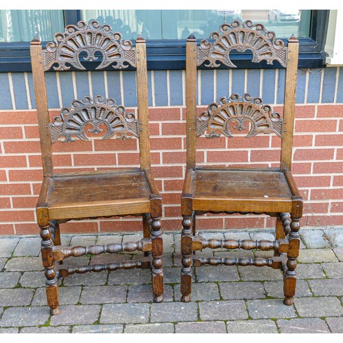 2047 - Pair of carved Oak hall chairs on Bobbin Twist supports (a/f -central panel damage) (2)