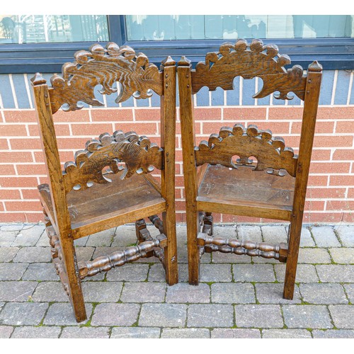 2047 - Pair of carved Oak hall chairs on Bobbin Twist supports (a/f -central panel damage) (2)