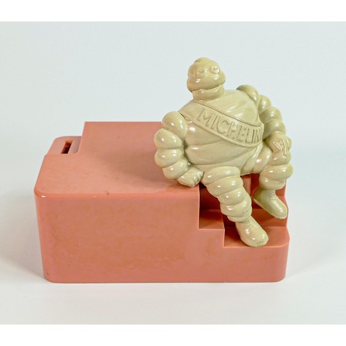 2240 - Michelin bakelite employees money box, modelled as a seated Mr Bibendum to pink base, h.13cm x w.15c... 