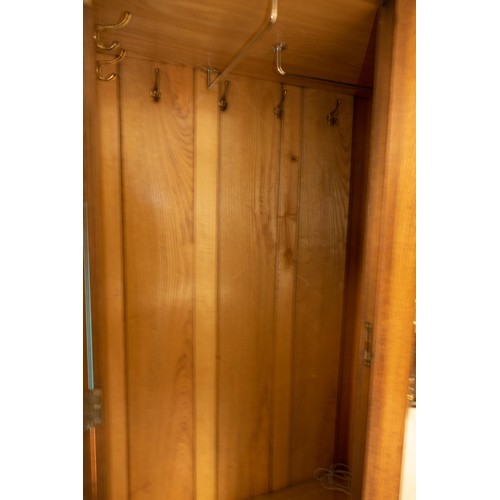 2073 - Oak Arts & Crafts two door wardrobe with mirrored central bevelled edge panel. Mother of pearl inlay... 