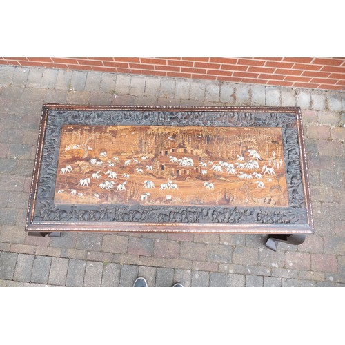 2082 - Large Indian carved coffee table, inlaid with elephants in their natural habitat. Later adapted to a... 