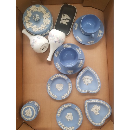 21 - A collection of Wedgwood jasperware items to include two cup and saucers, lidded pot, pin dishes, pa... 