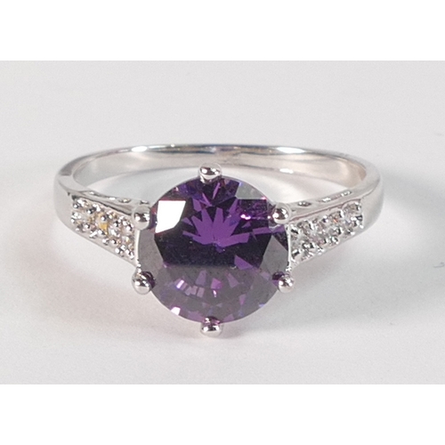 797 - 10k white gold dress ring set with round purple stone, size R,3.1g.