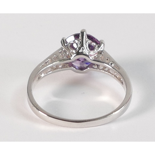 797 - 10k white gold dress ring set with round purple stone, size R,3.1g.