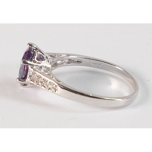 797 - 10k white gold dress ring set with round purple stone, size R,3.1g.