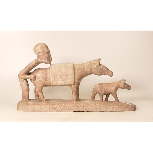 121 - Carved Stone Ethnic Figure of Farmer at work with Donkey, length 37cm