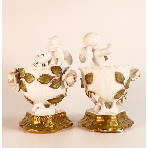 873 - James Shaw & Sons, pair of small vases, with applied naturalistic roses to vase flanked by Putti hol... 