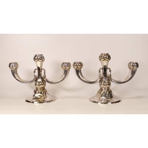 287 - A Pair of Alpacca Silverplate Three-branch Candlesticks. Marked 'Alpacca Import' to bases (2)