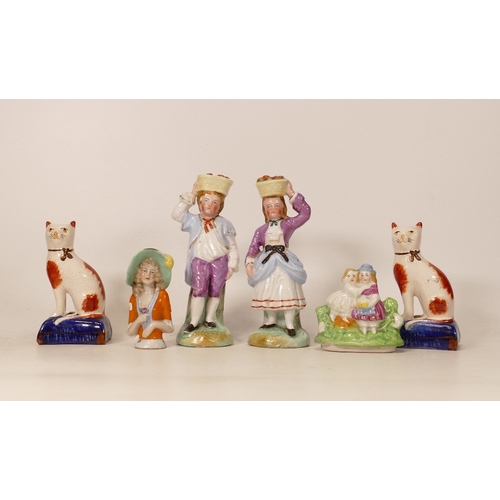 299 - A collection of Reproduction Staffordshire type figures including fruit carriers, cats , pin cushion... 