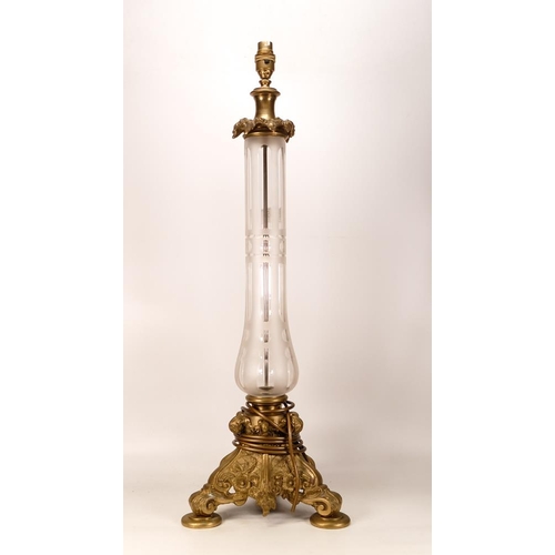 517 - Glass and gilt brass lampbase. Gilt brass collar decorated with leaves with a clear/frosted glass st... 