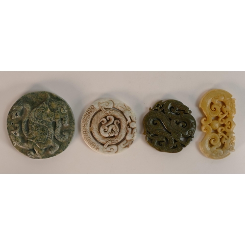 731 - A collection of Chinese carved hardstone roundels in different colours, largest d.8.5cm. (4)