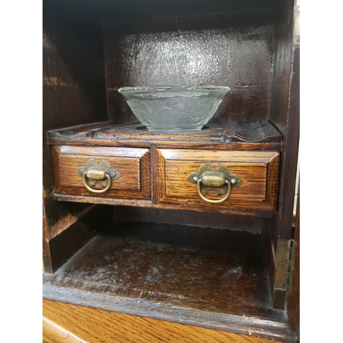 697 - Small Oak smokers cabinet with interior shelving and mixing accessories