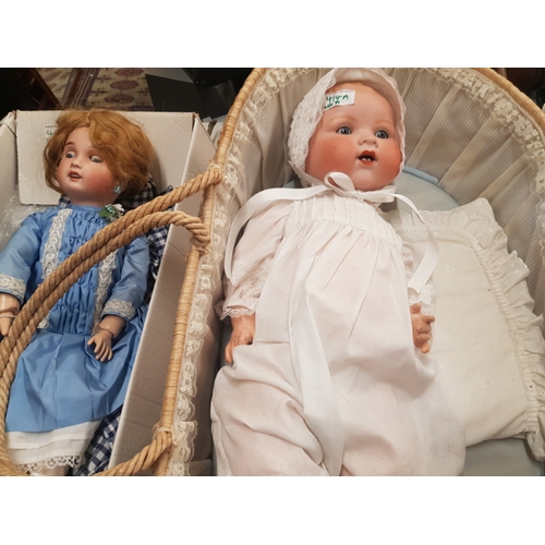 414A - Two vintage headed porcelain Dolls one marked AM Germany in wicker cot and one marked Limoges (2)