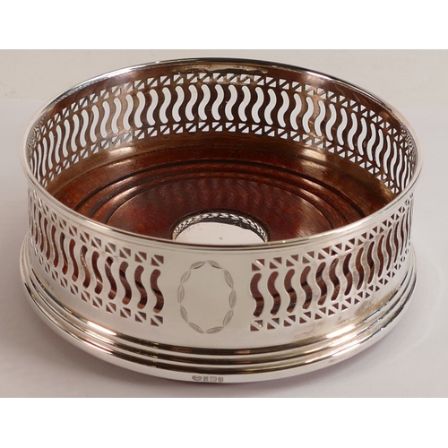 695 - Hallmarked modern silver bottle coaster with wooden base