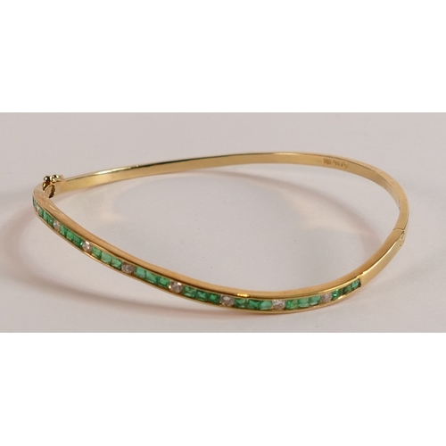 697 - 18ct gold diamond and emerald bangle, weight 8.4g.