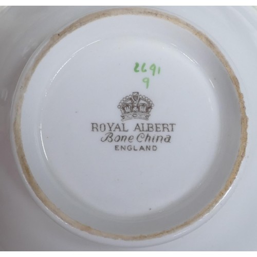 54 - A large collection of Royal Albert dinner ware decorated with ivy leaves and red berries to include ... 