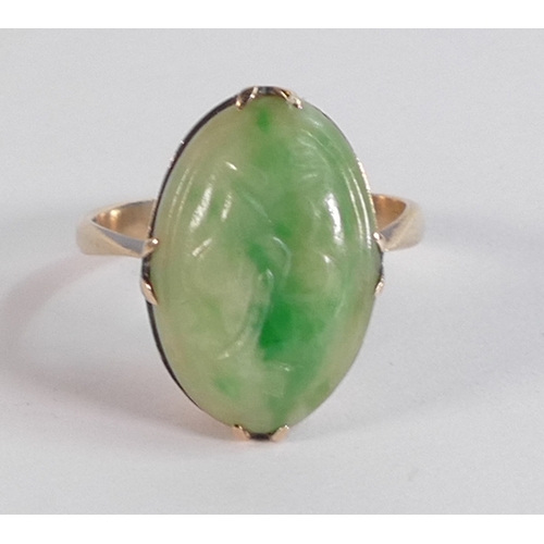 689 - 9ct gold ring set with carved Jade oval stone, ring size O/P, 4.2g.