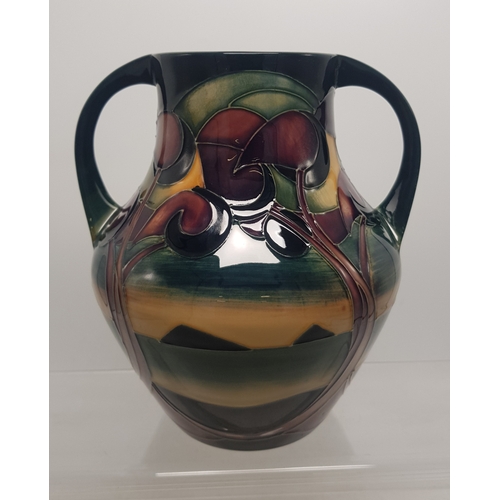 584 - Moorcroft Twin handled vase with sinuous tree decoration 18cm height. Red dot seconds