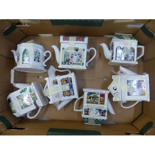 411 - A collection of Wade teapots to include The Antique Shop, Pet Shop, Fish & Chip Shop etc (7).