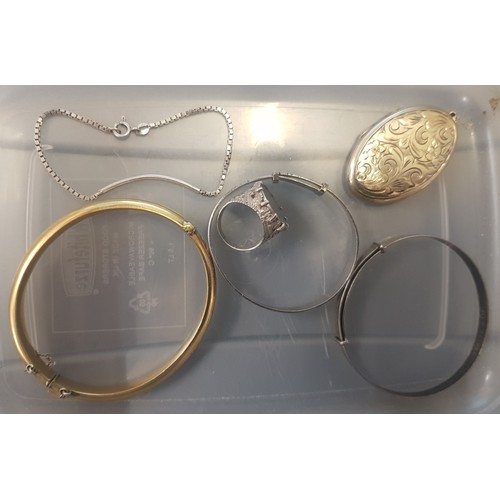 520B - A collection of silver items to include a silver gilt locket pendant, 2 silver bangles, a silver bra... 