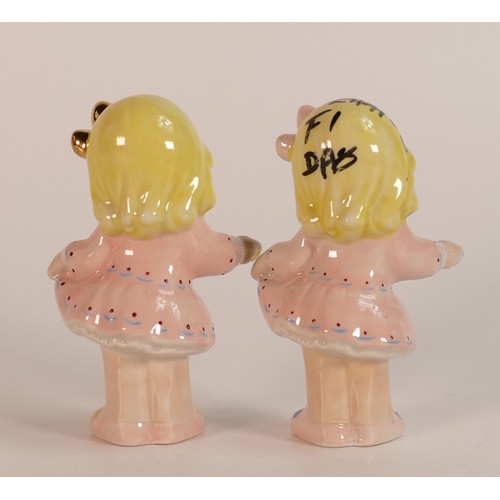 28 - Two Wade figurines of a girl in pink dress holding a cup. In different colourways, one marked F1 dat... 