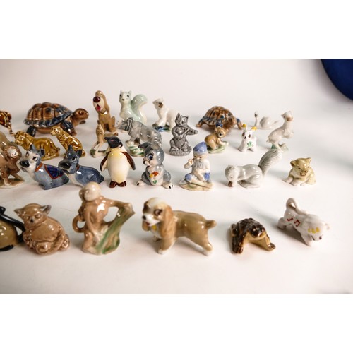 52 - A good collection of Wade Whimsies comprising Disney and first version Whimsies including Merlin as ... 