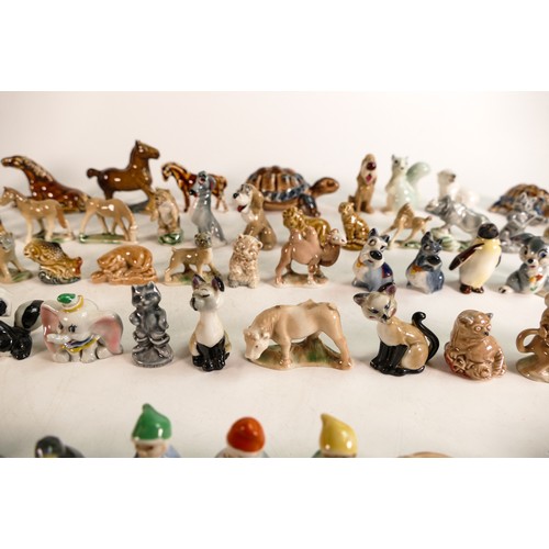 52 - A good collection of Wade Whimsies comprising Disney and first version Whimsies including Merlin as ... 