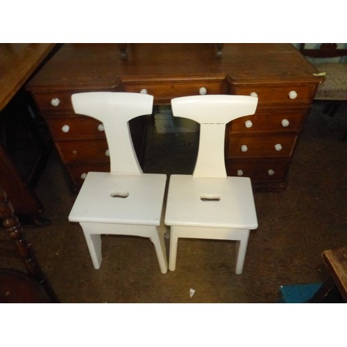 696 - Two White Overpainted Ecclesiastic Stools with carry handles carved into the seats. Height: 81cm