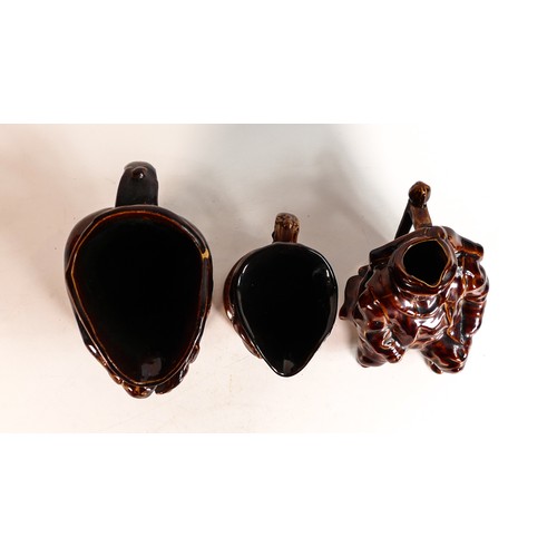 40 - Three Rockingham style treacle glazed character jugs, tallest 23.5cm - two at fault. (3)