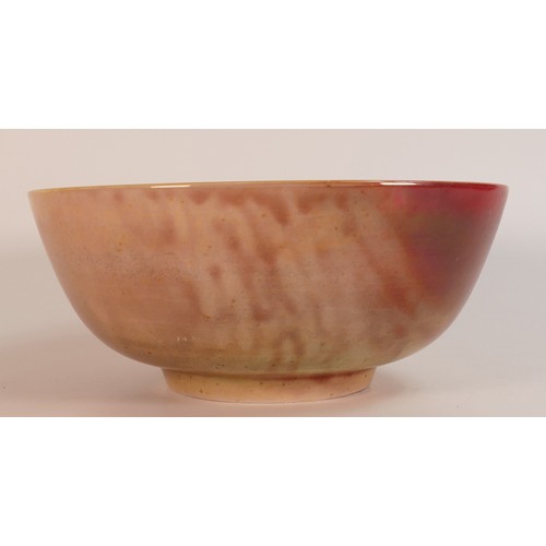 64 - Jonathan Cox Ceramics vibrantly decorated fruit bowl with lustre peacock decoration, diameter 25.5cm