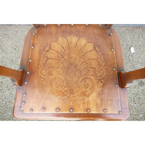 317 - An Early 20th century Armchair. Carved pediment and back with turned supports and stretcher. Panel t... 