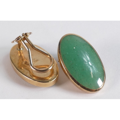 725 - Pair 9ct gold gold earrings each set with oval green possible Jade stones, 7.7g.