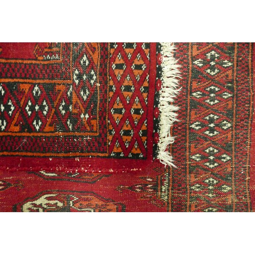 311B - An Uzbek Bukhara Type Rug. Wear and fraying present. Length: 124cm Width: 63cm